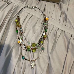 Layered beaded cross necklace.